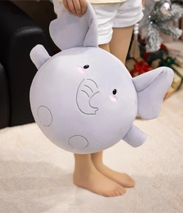 Soft purple elephant plush toy cushion with cute 3D ears in a festive holiday setting
