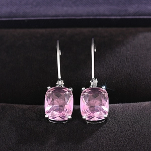 Pink cushion cut crystal drop earrings on purple velvet background in a silver setting