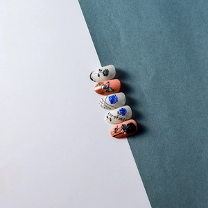 5D embossed nail art stickers featuring blue roses, butterflies, and pearls on white tips