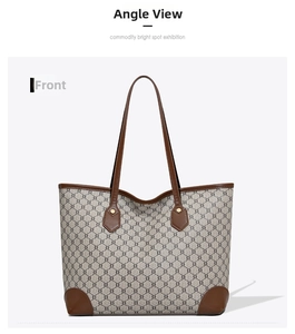 Detailed front view of a large vintage tote bag with beige pattern and brown leather trim