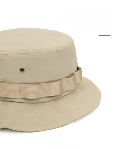 Detail of wide brim sun hat featuring metal eyelets and decorative woven band trim