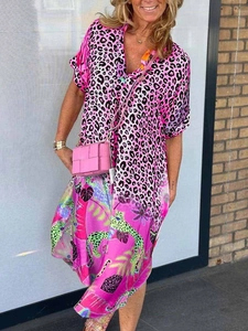 Close-up of pink leopard and tropical floral print dress with a pink woven handbag