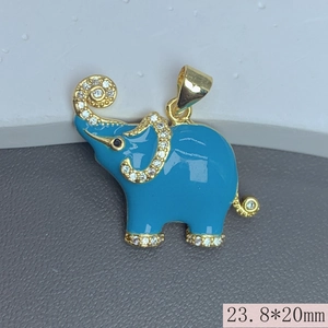 Macro detail of blue enamel elephant pendant with gold finish and zircon accents 23.8x20mm