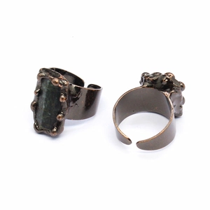Detail of adjustable vintage bronze rings with large dark rectangular agate geode stone