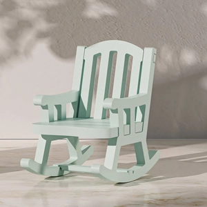 Vintage mint green wooden rocking chair with tall backrest on marble floor