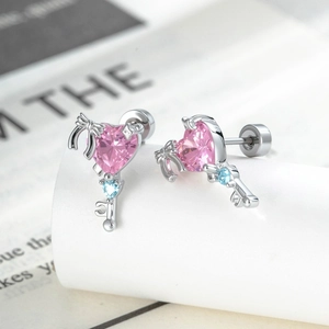 Pink heart zircon key stud earrings with bow design on white display stand