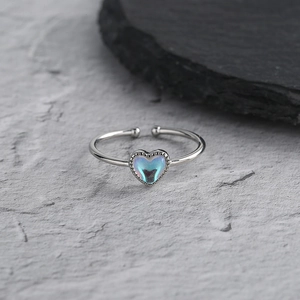 Detailed close-up of heart-shaped moonstone ring with elegant beaded edge detailing