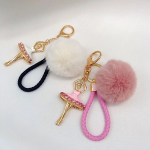 Detail of ballet girl keychains with rhinestones, pearls and fluffy pompom charms