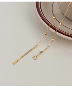 Detailed macro shot of S925 sterling silver stamp on golden pearl necklace clasp