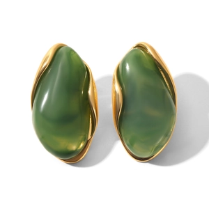 Detail of vintage oval green resin earrings with polished gold-tone metal base
