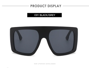 Detail view of oversized square black frame sunglasses with grey lenses, style C01