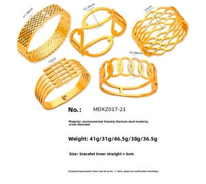 Detail of five geometric gold-plated titanium steel bangles with sparkling Czech crystals
