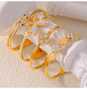 Detailed gold-plated titanium bracelets with butterfly, swan, and clover diamond motifs