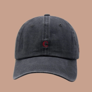 Close-up of vintage washed cotton baseball cap with red embroidered letter C detail