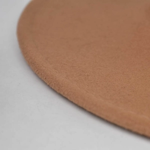 Close-up of thick brown wool felt fabric texture and clean edge on a fedora hat