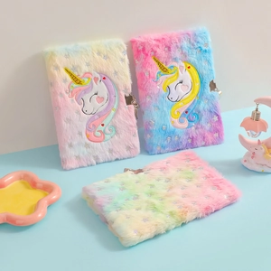 Detail of plush unicorn notebooks with tie-dye gradient colors and metal locks