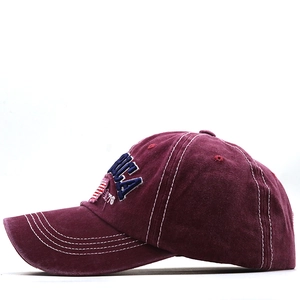 Detail view of burgundy washed cotton baseball cap with USA 1776 3D embroidery and white stitching