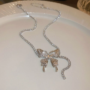 Elegant silver butterfly tassel necklace with full zircon pavé crystals on white porcelain