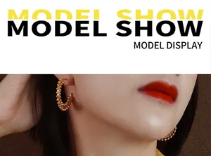 Close-up of golden beaded texture hoop earrings shown on a model for a stylish look