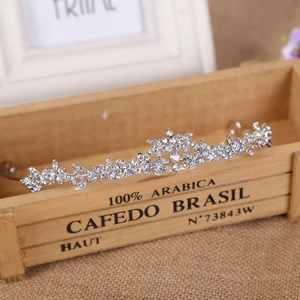 Detail of silver bridal crown with sparkling rhinestones on a rustic wooden base