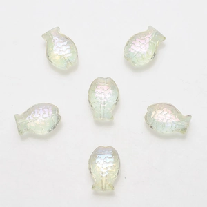 Macro shot of 6 iridescent fish-shaped crystal beads with textured scales for DIY jewelry