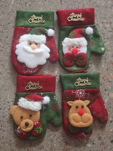 Set of four Christmas cutlery holders with Santa and Snowman plush holiday decorations