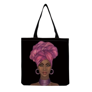 Detail of reusable black canvas tote bag featuring an ethnic portrait art print