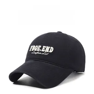 Detail of embroidered FBQE.END text on black cotton twill baseball cap with curved brim