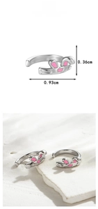 Detail view of rabbit ear ear cuffs in silver with pink enamel and size measurements