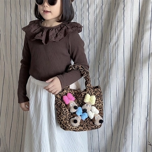 Kids vintage outfit with brown ruffled shirt, white skirt and plush leopard handbag