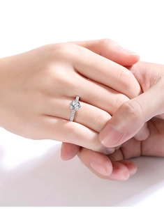Close-up of a classic 1ct moissanite S925 silver ring on hand for wedding proposal