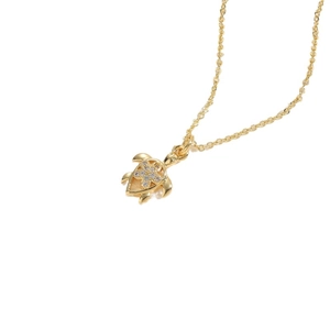 Elegant gold turtle pendant necklace with flower crystal accents on white background