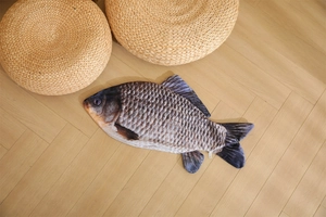 Detailed realistic fish plush toy texture and scale print on a wooden floor background