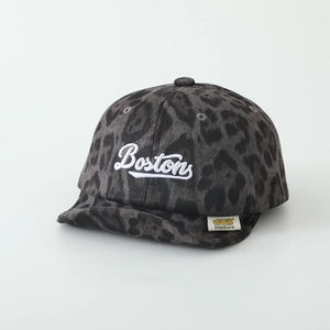 Detail showing the leopard print fabric and 3D embroidered Boston letters on the baby hat