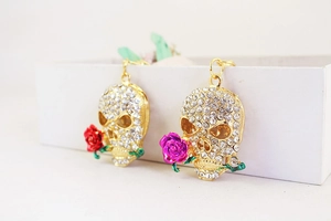 Detail of rose skull keychains with sparkling rhinestones and golden metal ring