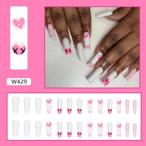 Detailed set of long square press-on nails with pink heart and black X patterns