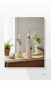 Detail of hand-painted pastoral rabbit figurines on a wooden table with soft lighting