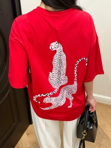 Detailed back view of oversized red T-shirt featuring artistic twin leopard print design