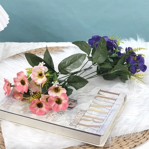 Silk cherry blossom bouquet with pink and purple flowers on a luxury wedding book