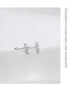 Macro view of minimalist S925 silver stud earrings with micro-set zircon and screw back