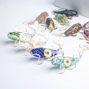 Macro detail of resin koi fish figurines with natural crystal stones and gold foil