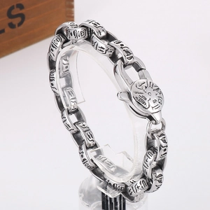 Macro detail of vintage silver oval link bracelet with engraved Egyptian hieroglyphs