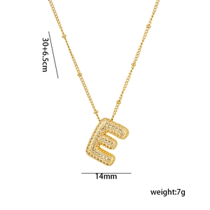 Detail of 18K gold letter E pendant with zircon inlay and product measurements