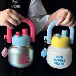 Detail of dual-drink thermal mugs with portable handles and cute monster charms