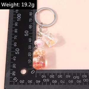 Detailed view of ocean-themed wishing bottle keychain with pink pearls and shells