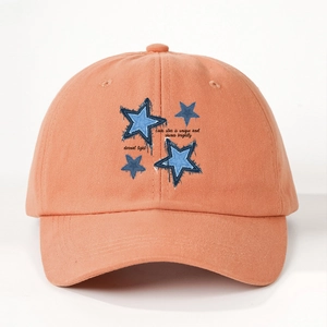 Detail of orange cotton baseball cap featuring blue stars and eternal light embroidery