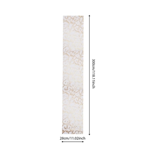 Detail of white mesh table runner with gold star foil pattern showing dimensions 300x28cm
