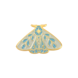 Golden moth enamel pin with light blue wings and star moon patterns for clothing