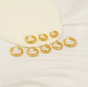 Close-up of polished 18K gold plated stainless steel hoop earrings in multiple sizes
