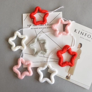 Felt star Christmas ornaments in red white pink and grey with hanging strings